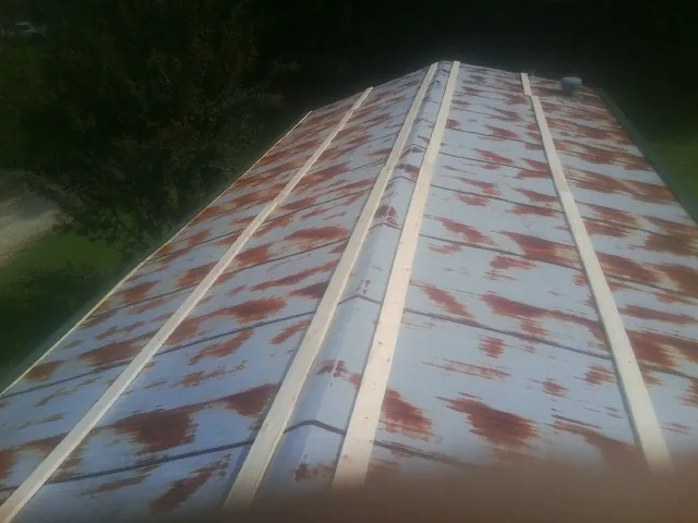 Rusted metal roof panels with new wood purlins before replacement — Storm Damage Roof Repair in Lake Mary by Roofing Brothers